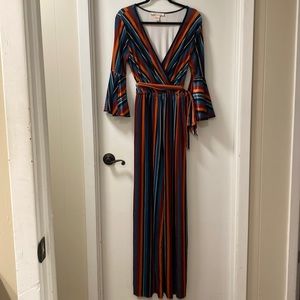 Size Large Velour multi-color striped jumpsuit.